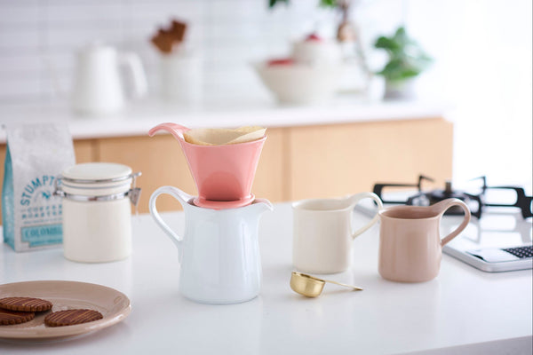ZERO JAPAN Kitchen counter with coffee-making setup, including a pink pour-over coffee maker and various mugs.